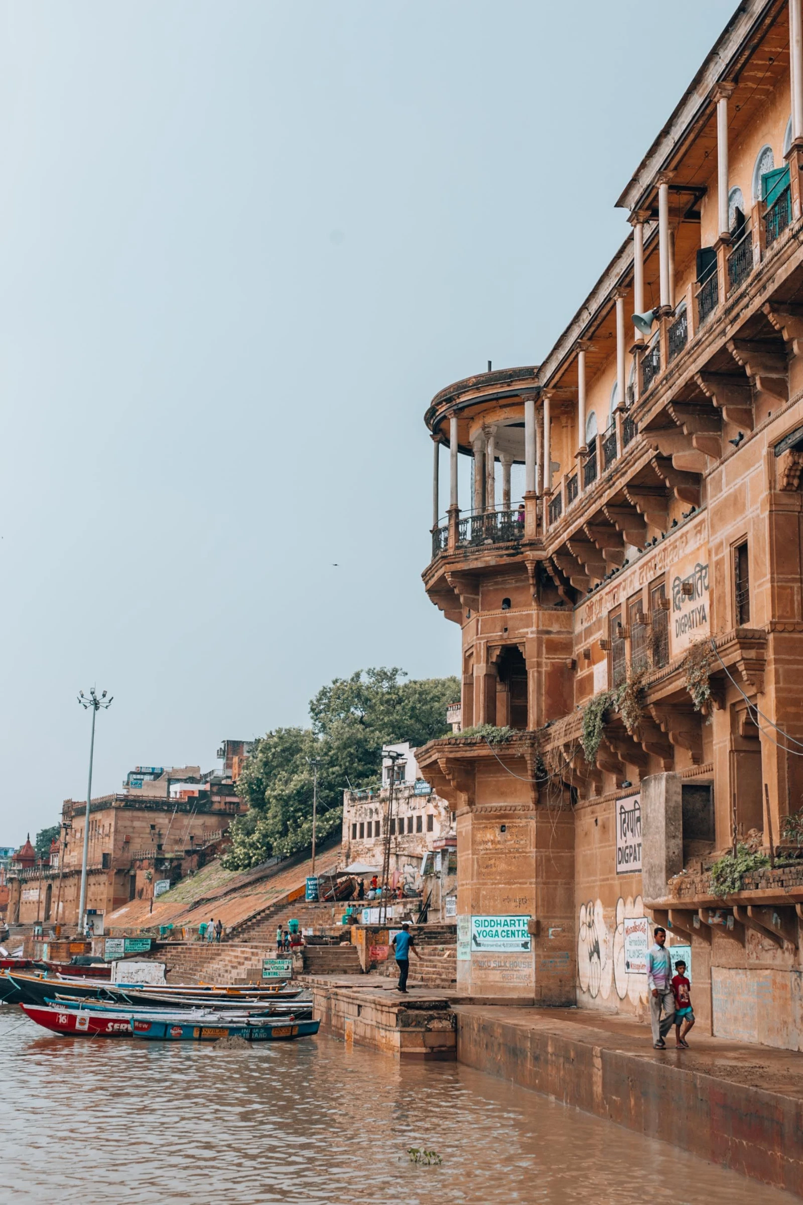 The broad stone steps of the Varanasi ghats leading down to the Ganga