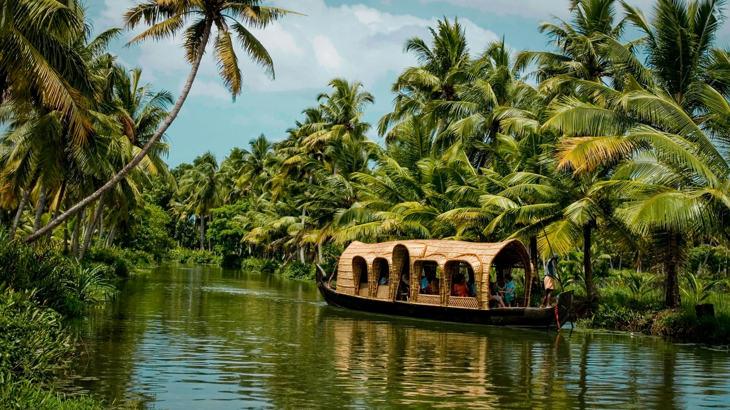 A wooden boat on the palm-fringed backwaters of Kerala in south India
