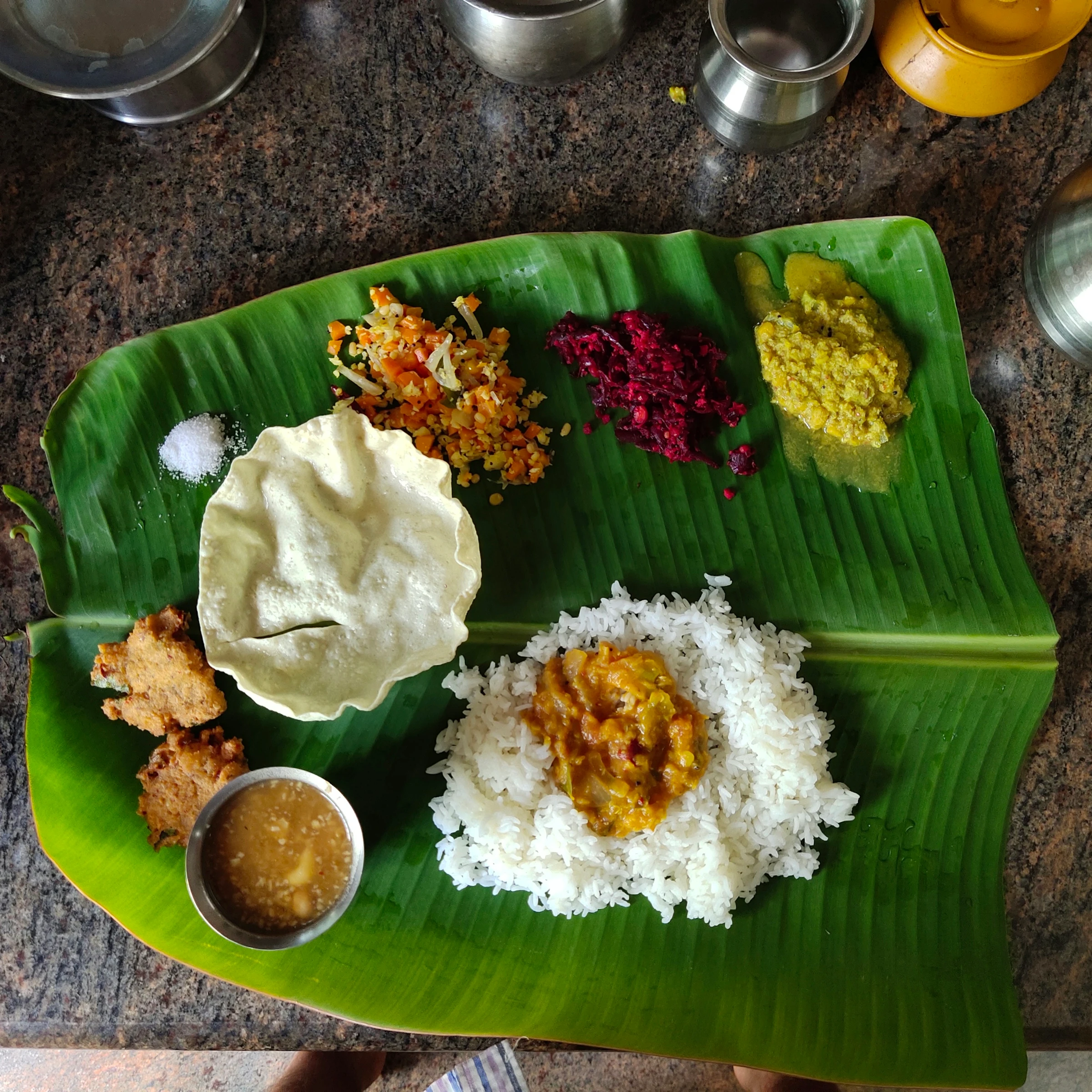 A South Indian banana-leaf meal with rice, vegetable curries, pickles and pappadam