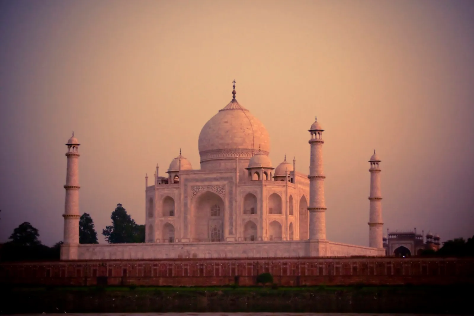 The white marble Taj Mahal beside the Yamuna river, seen from the garden bank